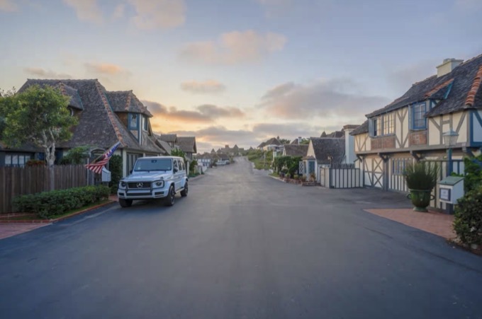 Children riding beach cruisers down a quiet paved lane