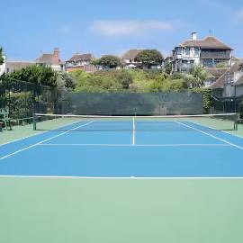 Sun-drenched tennis court inside the community